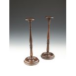 A PAIR OF VICTORIAN STYLE MAHOGANY WIG-STANDS, the turned columns on dished circular base. 39cm