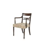 A GEORGE IV MAHOGANY FRAMED CURVED RAIL BACK ELBOW CHAIR with reeded decoration, padded seat and