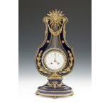A FRENCH BLUE ENAMEL AND ORMOLU MOUNTED LYRE-SHAPE MANTLE CLOCK, 19th century, surmounted with a