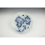 A JAPANESE 18TH CENTURY BLUE AND WHITE CHARGER, of circular form with wavy rim, painted with