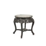 A CHINESE CARVED FRUITWOOD CIRCULAR JARDINIERE STAND, the top with inset marble and raised on