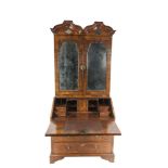 AN 18TH CENTURY QUEEN ANNE WALNUT VENEERED BUREAU CABINET, with a flat double domed cornice above