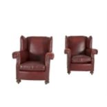 A PAIR OF EDWARDIAN RED LEATHER WING BACK ARMCHAIRS, each with stuffed rectangular back, loose