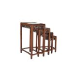 A CHINESE FRUITWOOD NEST OF QUARTETTO TABLES, with moulded tops above leaf carved aprons, curved