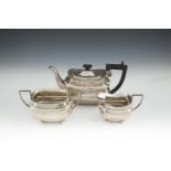 A GEORGE V SILVER THREE PIECE TEA SERVICE, Birmingham 1922/23, mark of J.G. Ltd., of shaped