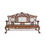A CHINESE CARVED FRUITWOOD SETTEE, the back decorated with dragons and flowerheads and with inset