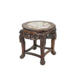 A CHINESE CARVED FRUITWOOD SHAPED CIRCULAR JARDINERE STAND, the top with inset marble and raised