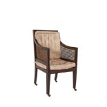 A GEORGE IV MAHOGANY BERGÈRE ARMCHAIR, with cane back and sides, raised on square tapering legs