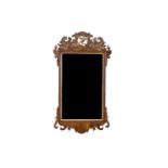 A 19TH CENTURY WALL MIRROR, fitted with rectangular plate below a pierced crest, centred with ho