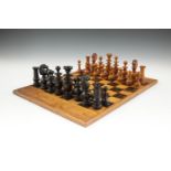 A FRENCH EBON AND OLIVEWOOD 'RÉGENCE' PATTERN CHESS SET, late 19th Cenutry, the Kings