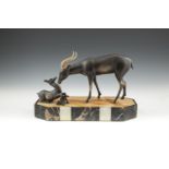 AN ART DECO STYLE BRONZED GROUP, modelled as Thompson's Gazelles, standing on sienna marble base,