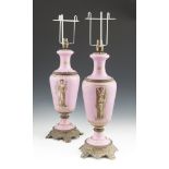 A PAIR OF VICTORIAN PINK PORCELAIN BALUSTER TABLE LAMPS, decorated with Classical Roman figures,