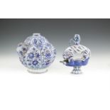 AN IZNIK STYLE BLUE AND WHITE KENDI of lobbed globular form, decorated with panels filled with