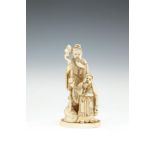 A JAPANESE CARVED IVORY OKIMONO, 19th century, of a sage, standing with staff and attendant on