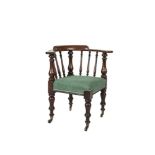 A VICTORIAN MAHOGANY FRAMED CORNER ARMCHAIR of robust construction with padded seat, raised on