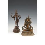 A TIBETAN BRONZE TANTRIC GROUP, modelled as embracing figures, seated on inverted lotus base,