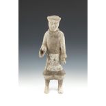 A CHINESE POTTERY HAN DYNASTY BURIAL FIGURE, modelled as a standing warrior, decorated in cream