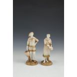 A PAIR OF ROYAL WORCESTER PORCELAIN FIGURES, of a standing male and female each carrying baskets,