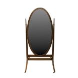 A MAHOGANY CRUTCH FRAMED CHEVAL MIRROR, c.1900, the oval adjustable plate between tapering upright