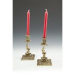 A PAIR OF 19TH CENTURY CAST-BRASS CANDLESTICKS IN THE BAROQUE STYLE, each modeled with square