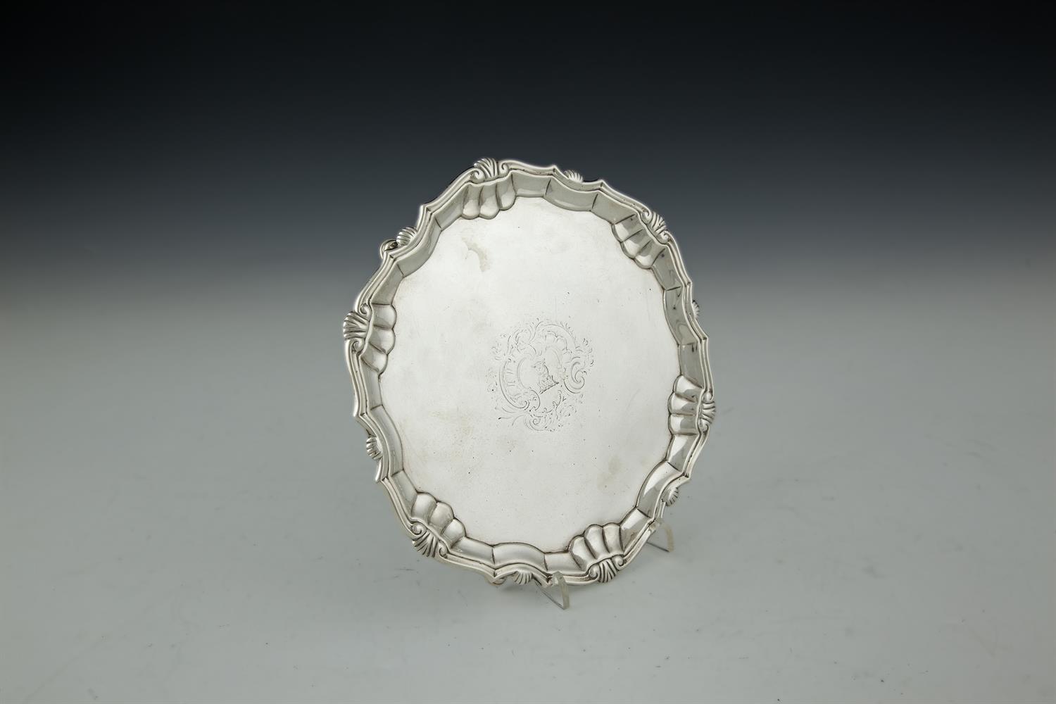 A GEORGE II SILVER SALVER, by Robert Abercromby, London 1740, of shaped circular form with plain