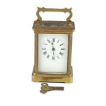 A SMALL BRASS CARRIAGE CLOCK, with white enamel dial. 10cm high