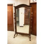 A LARGE 19TH CENTURY MAHOGANY FRAMED CHEVAL MIRROR, the arched rectangular plate surmounted with