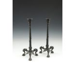 A PAIR OF 19TH CENTURY BRONZE EMPIRE STYLE TALL CANDLESTICKS, with leaf capitals and palm columns