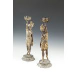 A PAIR OF COLD PAINTED FIGURAL CANDLESTICKS, c.1900, depicting a sultan and sultana, each standing
