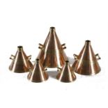 A SET OF FIVE BRASS AND COPPER HAYSTACK MEASURES, ranging from 2 litre to 20 litre, inscribed 'M.C.