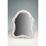 A CONTINENTAL PORCELAIN CARTOUCHE SHAPED EASEL DRESSING TABLE MIRROR, the white ground painted