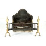 A CAST IRON AND BRASS FIRE GRATE, of serpentine outline and with urn finials. 80cm wide