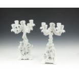 A PAIR OF MEISSEN BLANC DE CHINE PORCELAIN FIGURAL CANDELABRA, 19th century, each with four scroll