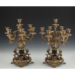 A VICTORIAN STYLE EBONISED AND GILT THREE PIECE CLOCK GARNITURE, comprising of a mantle clock,