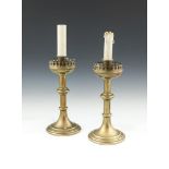 A PAIR OF LATE 19TH CENTURY BRASS CANDLESTICK TABLE LAMPS, in the Gothic taste with shades,