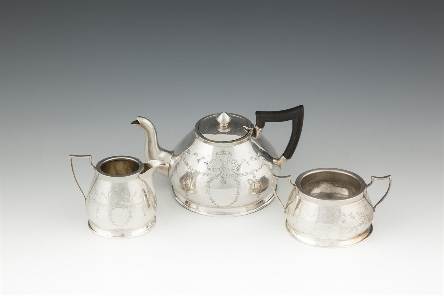 A SILVER THREE PIECE BACHELOR'S TEA SERVICE, Chester 1912, on piece hallmarked only, of domed shape,