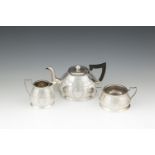 A SILVER THREE PIECE BACHELOR'S TEA SERVICE, Chester 1912, on piece hallmarked only, of domed shape,