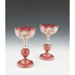 A PAIR OF VICTORIAN RED BOHEMIAN GLASS LUSTRE VASES, with alternating portrait panels. 29cm tall