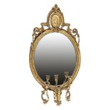 A FRENCH GILTWOOD AND GESSO THREE LIGHT GIRANDOLE WALL MIRROR, 19th century, of oval form,