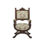 A 19TH CENTURY CARVED AND STAINED OAK FRAME ARMCHAIR, the upholstered padded back, armrests and seat