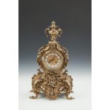 A FRENCH CAST BRASS MANTLE CLOCK, 20th century, surmounted by an urn over a gilt metal and enamel