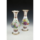 A PAIR OF 19TH CENTURY FLORAL PAINTED PORCELAIN VASES, of baluster form, each with flared serrated