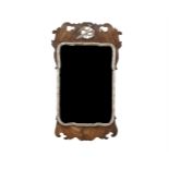 ***WITHDRAWN***A 19TH CENTURY WALNUT AND PARCEL GILT WALL MIRROR IN MID-GEORGIAN STYLE, the shaped