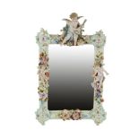 A MEISSEN STYLE PORCELAIN MIRROR, 19th century, the polychrome frame decorated with putti and all-