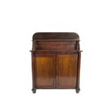 AN EARLY VICTORIAN MAHOGANY CHIFFONIER SIDE CABINET, with raised panel back and shelf above twin