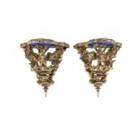 A PAIR OF VICTORIAN GILTWOOD AND GESSO WALL BRACKETS, of bowed form, the shaped platform top