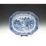 A LARGE CHINESE BLUE AND WHITE MEAT DISH, 18th century, of oblong form, painted with pagodas in a