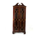 A MAHOGANY AND SATINWOOD CROSS BANDED AND EBON STRUNG CORNER CABINET, 19th century, with broken swan