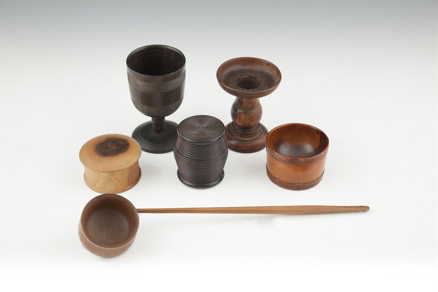 A COLLECTION OF GEORGIAN AND LATER TREEN, including lignum vitae bowl, stand, boxes and ladle. (6)