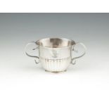 A RARE 18TH CENTURY TWO HANDLE SILVER DRAM CUP, of miniature form, applied with twin scroll handles,